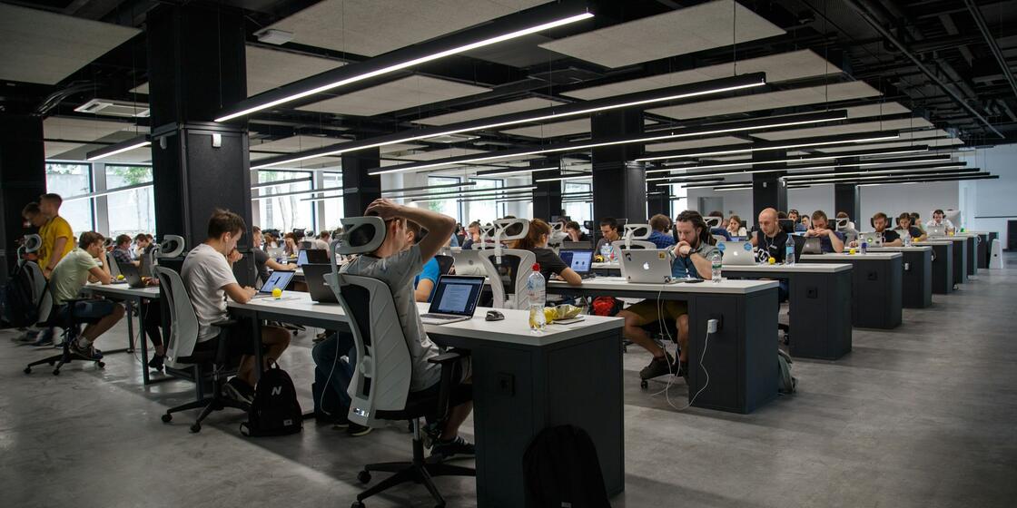 An open-plan office with teams at work
